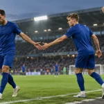 Dva fotbalisté ve stejných modrých dresech při střídání u postranní čáry